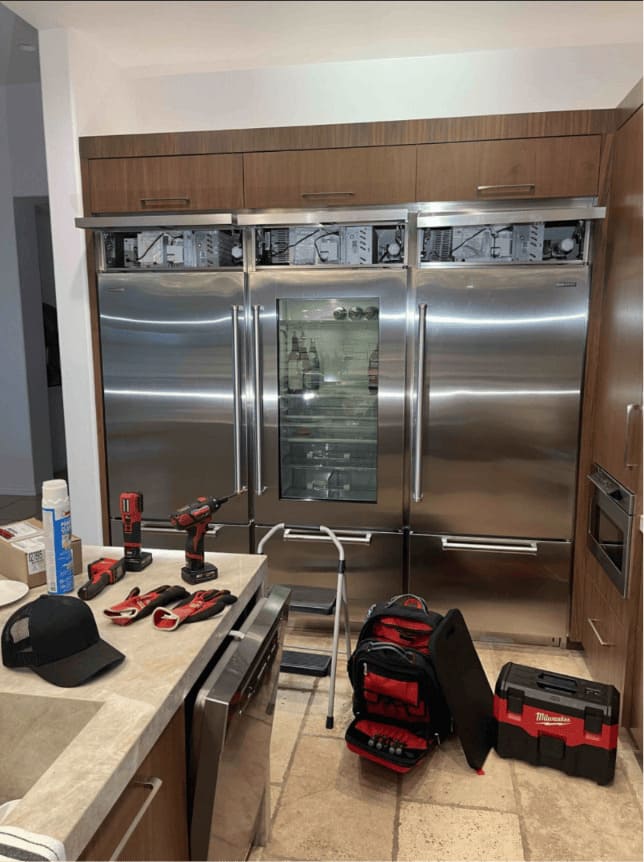 Sub-Zero repair in Chicago — three built-in Sub-Zero refrigerators serviced in a Chicago kitchen